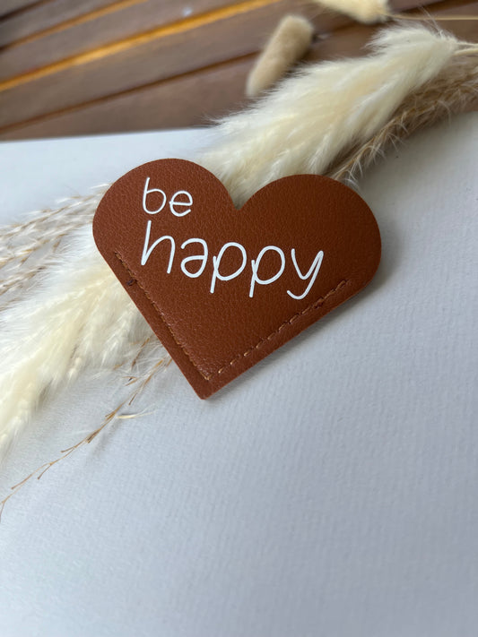 Lesezeichen in Herzform. be happy mit Smiley. Kunstleder in Braun